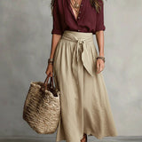 Vera – Two-piece set: black top and olive green midi skirt